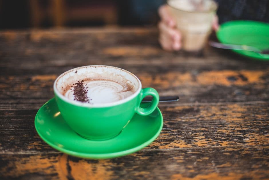 Cup of coffee on a wooden café table