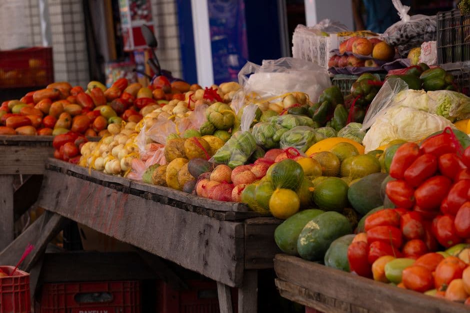 Outdoor market stall with a colourful display of fresh fruits and vegetables