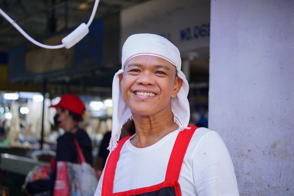 Friendly Filipino market vendor at a stall in Metro Manila