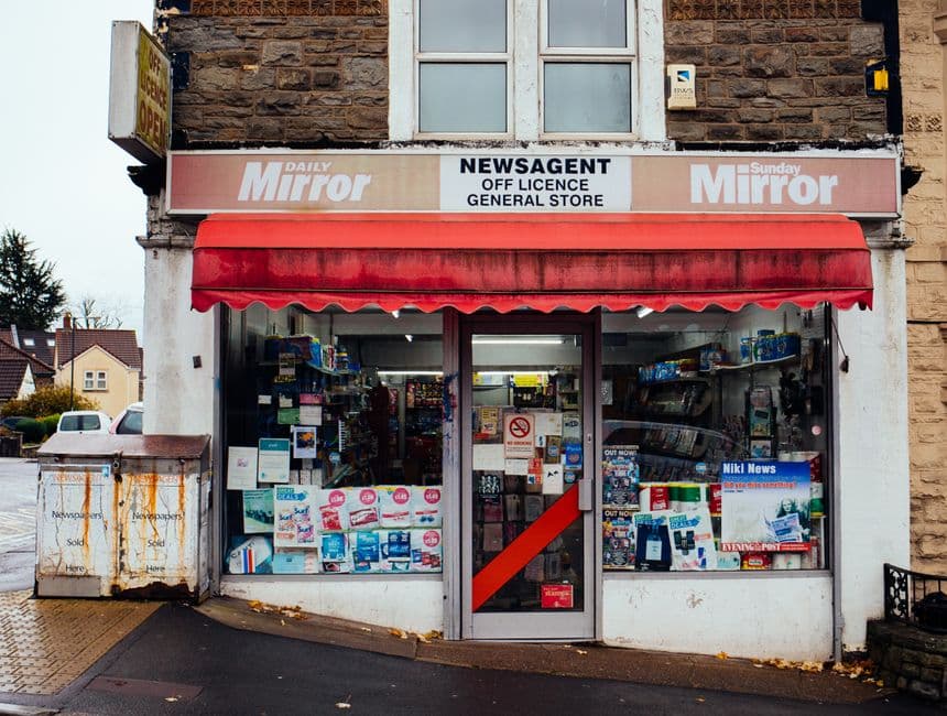 Classic British newsagent corner-shop storefront with signage and awning