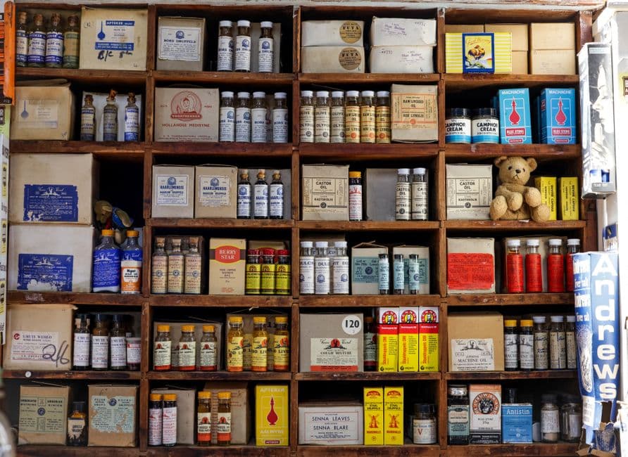 Medicine boxes on pharmacy shelves with batch and expiry tracking
